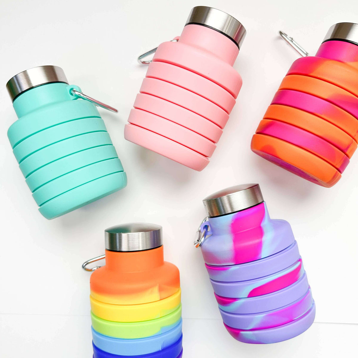 Set of colorful collapsible water bottles on a white background