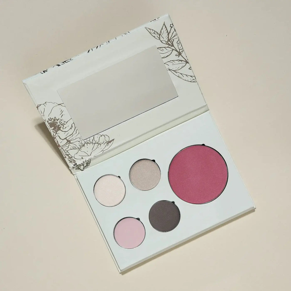 Makeup palette with four colors on a beige background