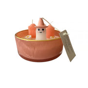 Candle with a small figurine inside on a white background