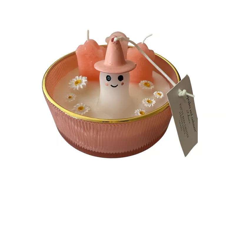 Candle with a ghost design in a pink bowl on a white background