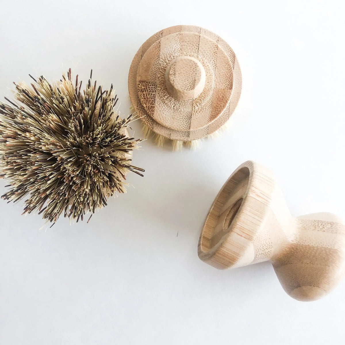 Three wooden cleaning brushes on a white background