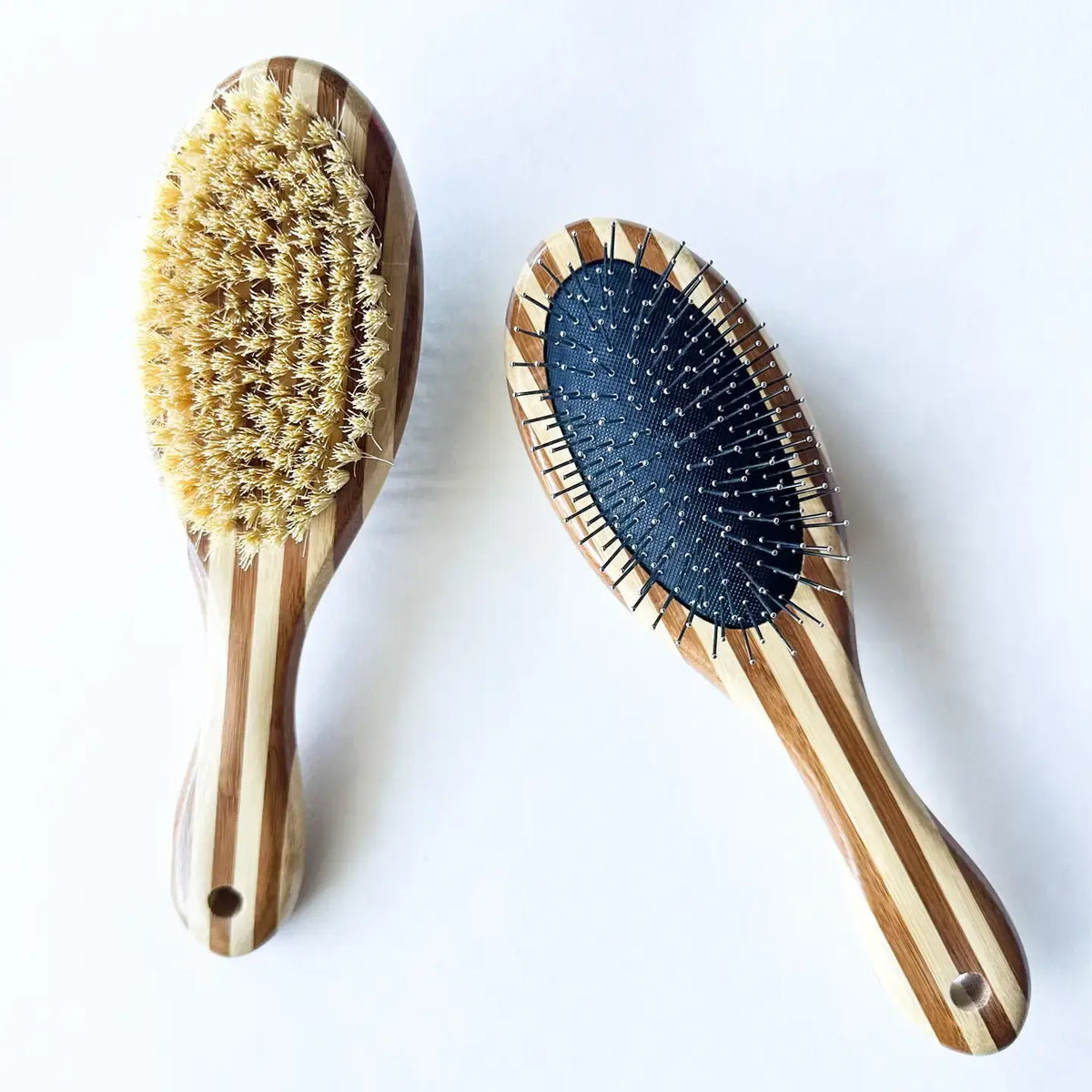 Two wooden hairbrushes with bristle heads on a white background
