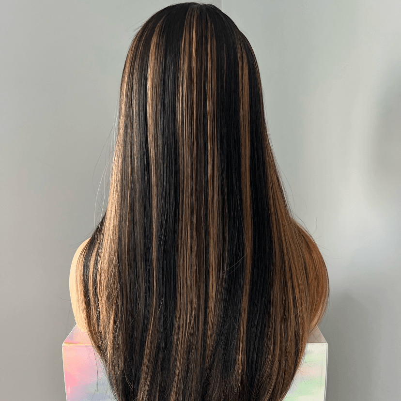 Mannequin head with long, dark brown hair on a gray background