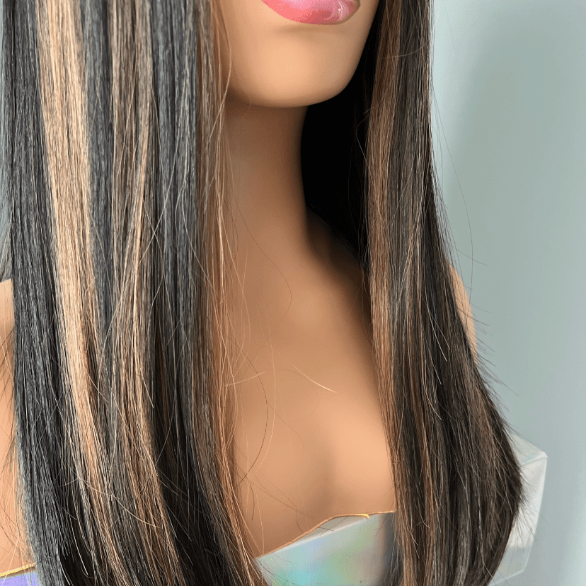 Mannequin head with long black and brown hair on a white background