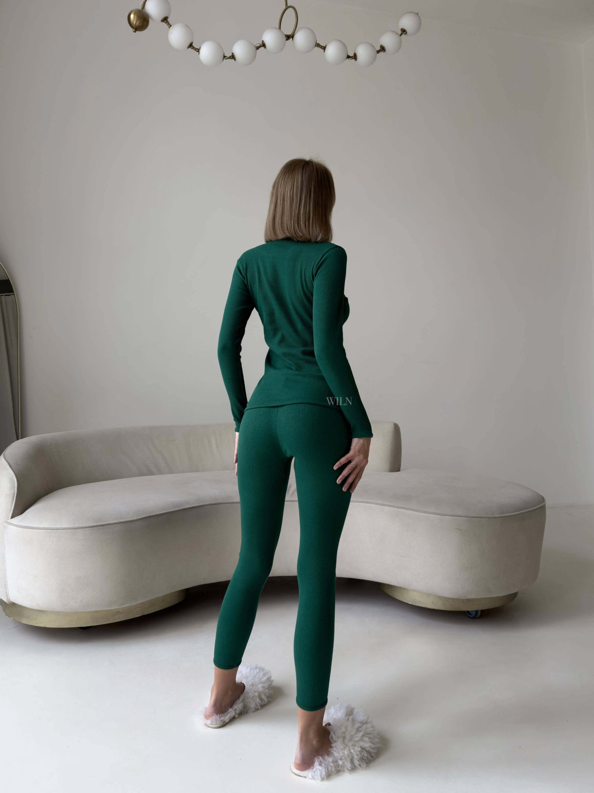 EASE 2 Piece Ribbed Cotton Loungewear - Green model showcasing the back view in a cozy living room setting.