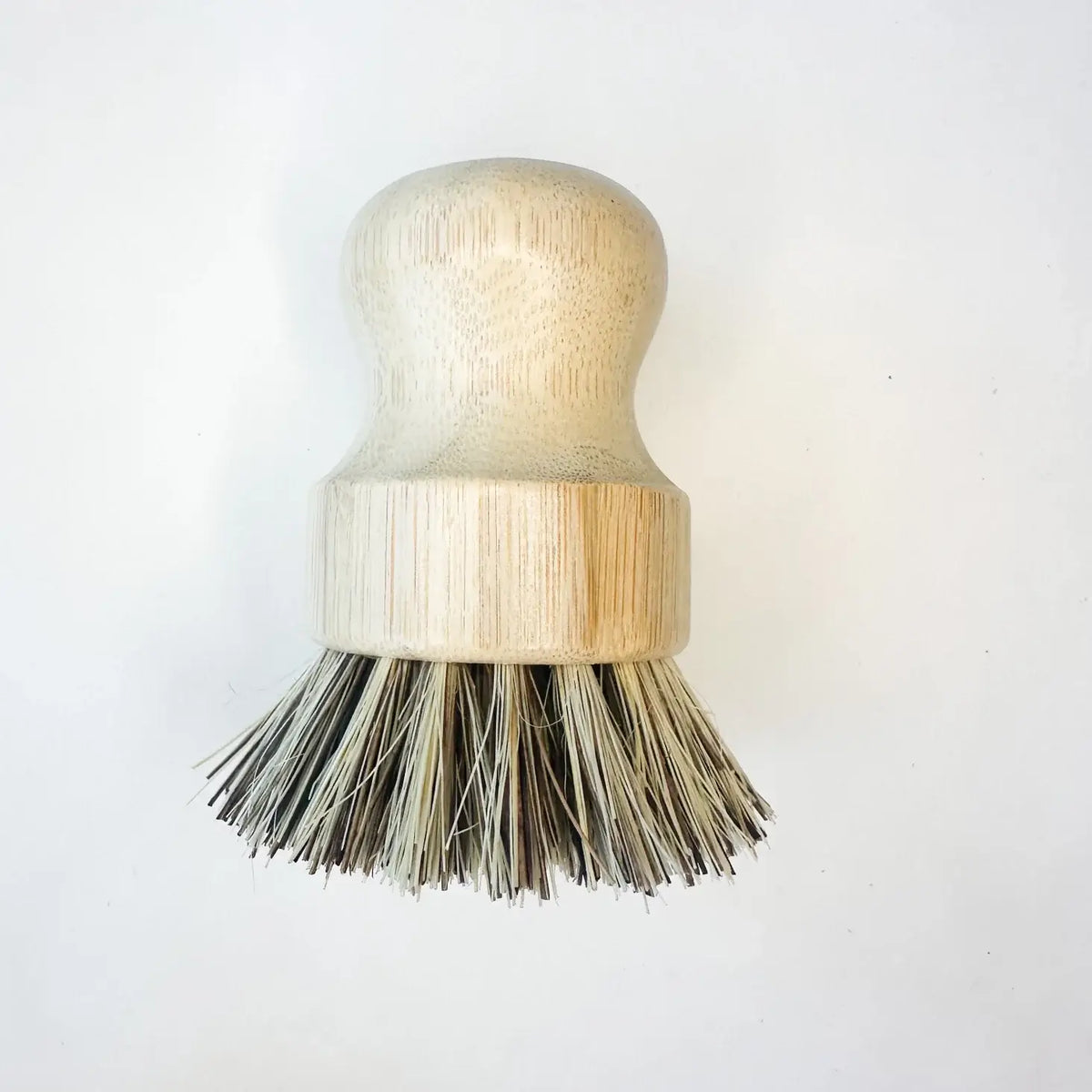 Dishwashing brush with wooden handle and bristles on a white background