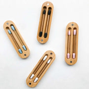 Set of four wooden toothbrush holders with toothbrushes on a white background