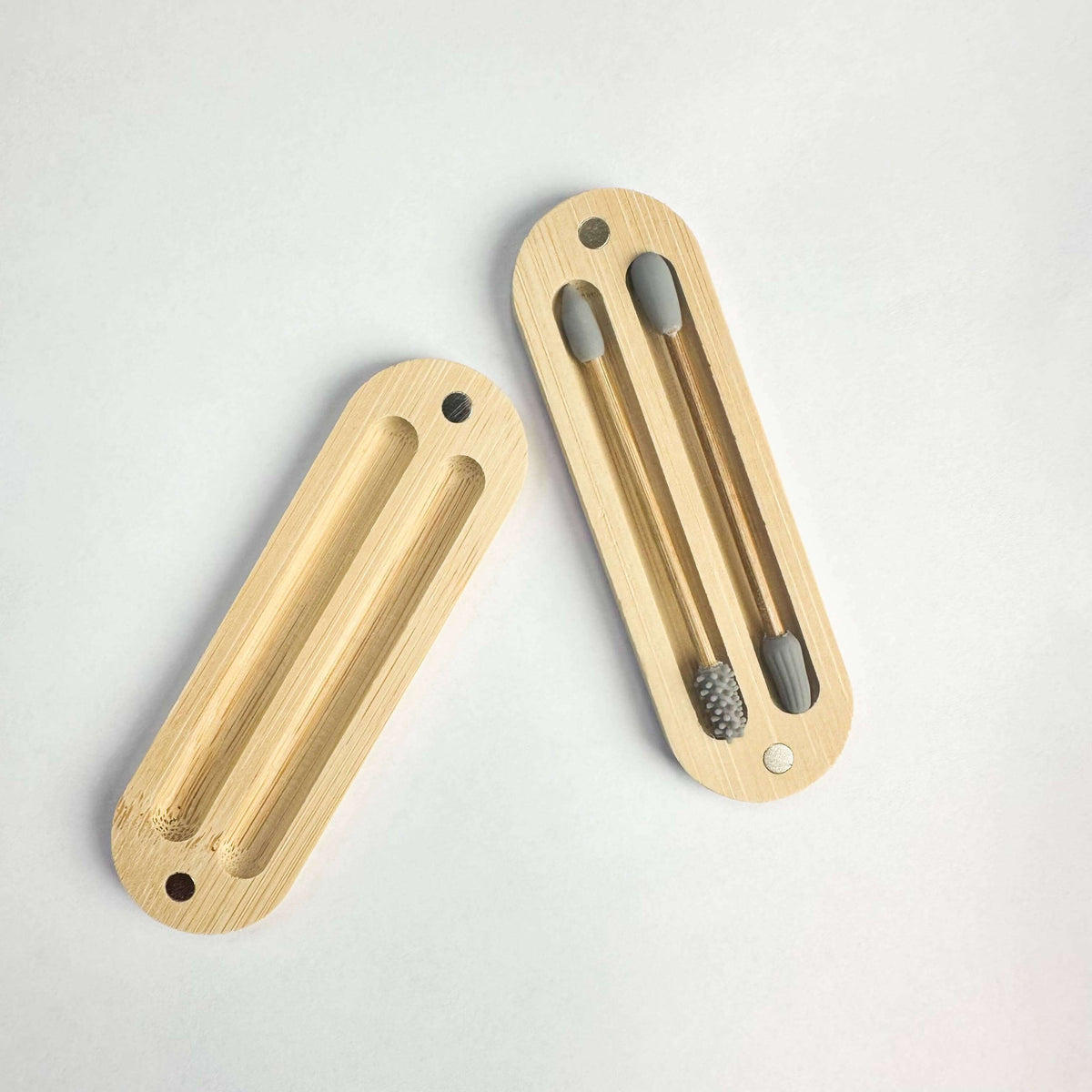 Two wooden door handles on a light gray background