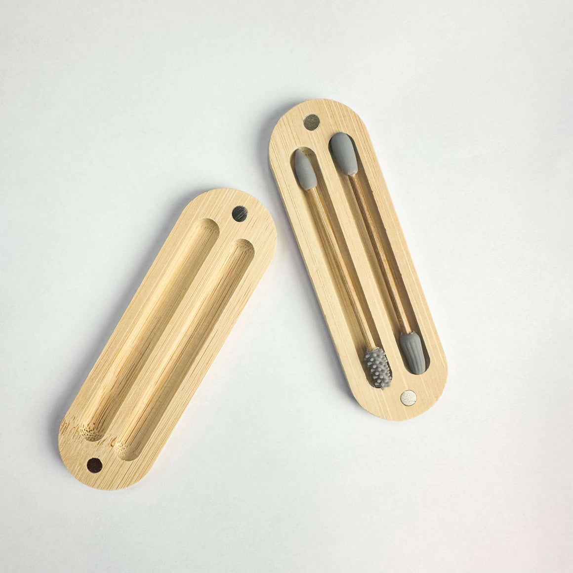 Two wooden door handles on a light gray background