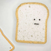 Toast with a face drawn on it on a white background