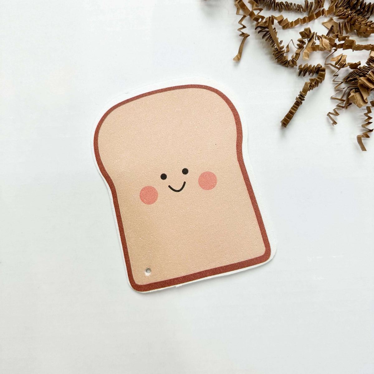 Sticker of a smiling piece of bread on a white background
