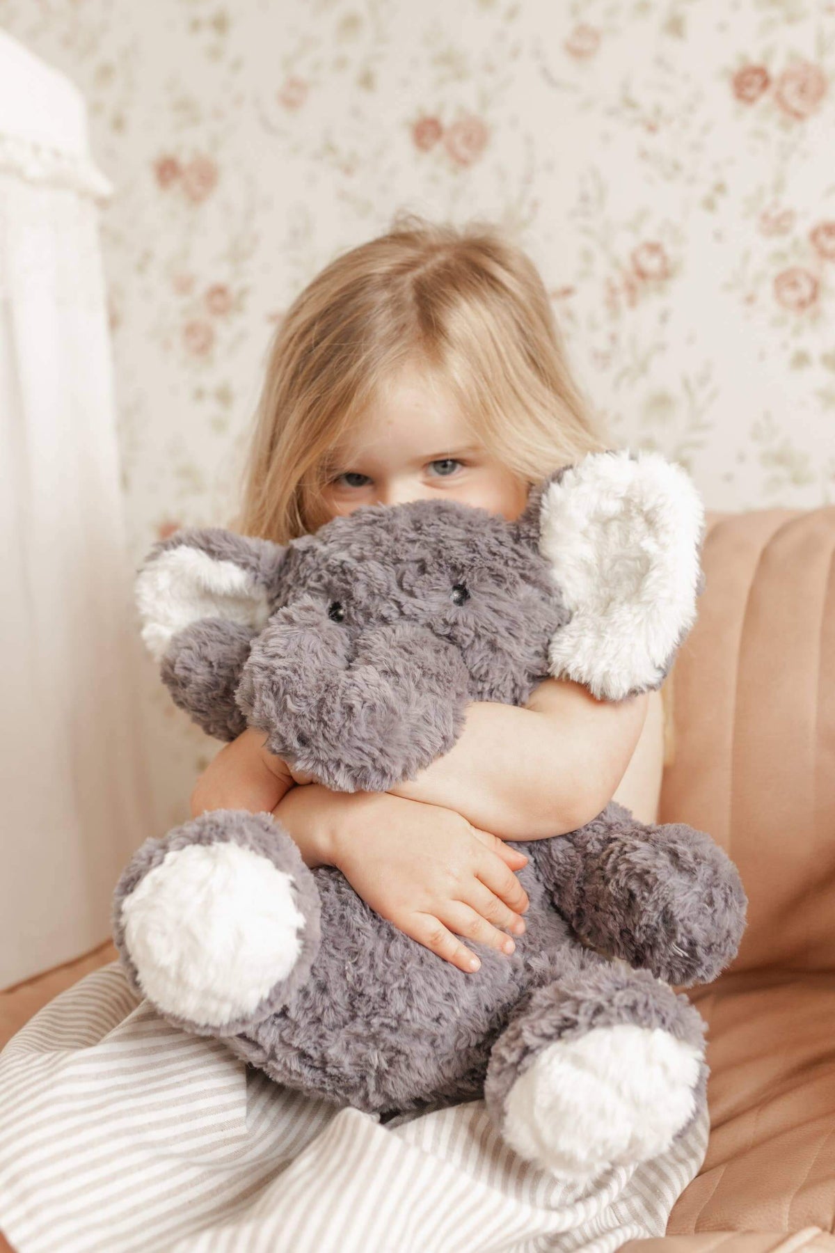 Child hugging Eleanor The Weighted Elephant plush toy for comfort and calm.