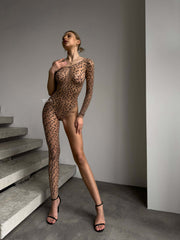 Model showcasing the FELINE Nude Bodysuit with cheetah print, emphasizing confidence and natural curves.