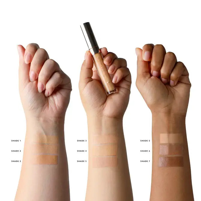 Fruit pigmented concealer for natural finish showing swatches of different shades on arms.