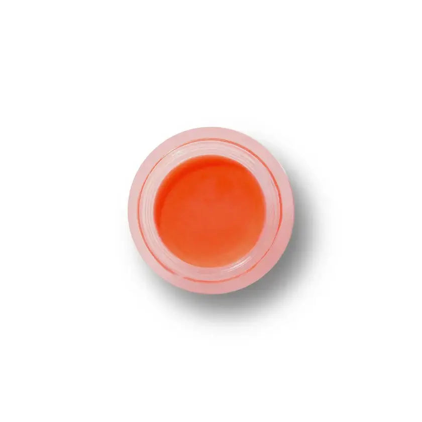 Small container of orange cream on a white background