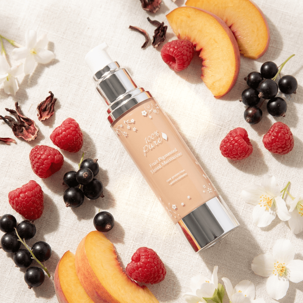 Fruit Pigmented® Tinted Moisturizer - 100% Pure 50 ml with fruits on a light background.