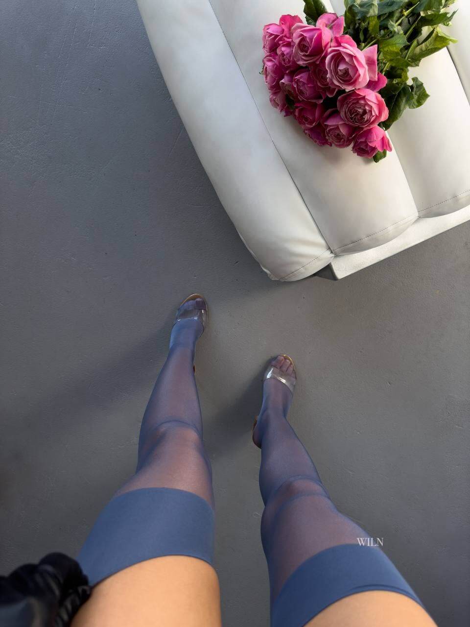 Elegant GLAM Stockings in navy blue paired with a bouquet of pink roses, showcasing a glossy sheer finish.
