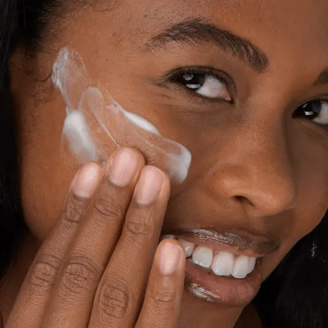 Woman applying Green Tea EGCG Concentrate Serum on her face, showcasing beauty and skincare routine.