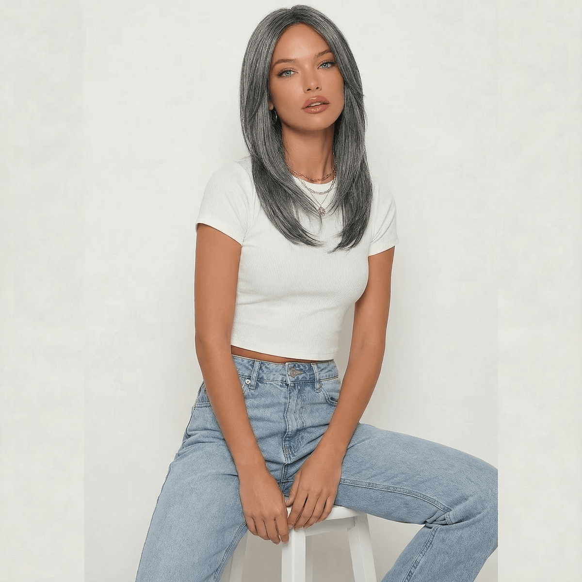 Dixie Dark Grey Layered Wig worn by a model, featuring cool-toned ash grey color and shoulder-length layers.