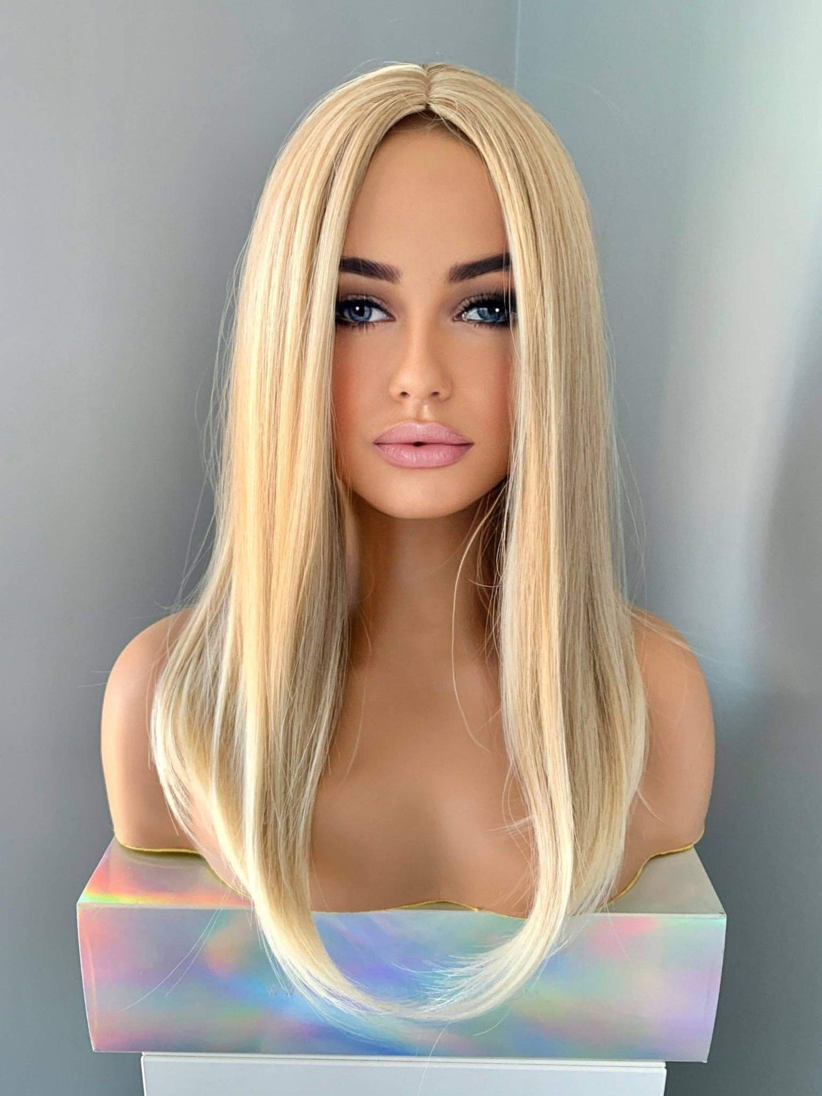 Hailey Silky Straight Blonde Wig displayed on a mannequin, showcasing its medium golden blonde color and sleek style.