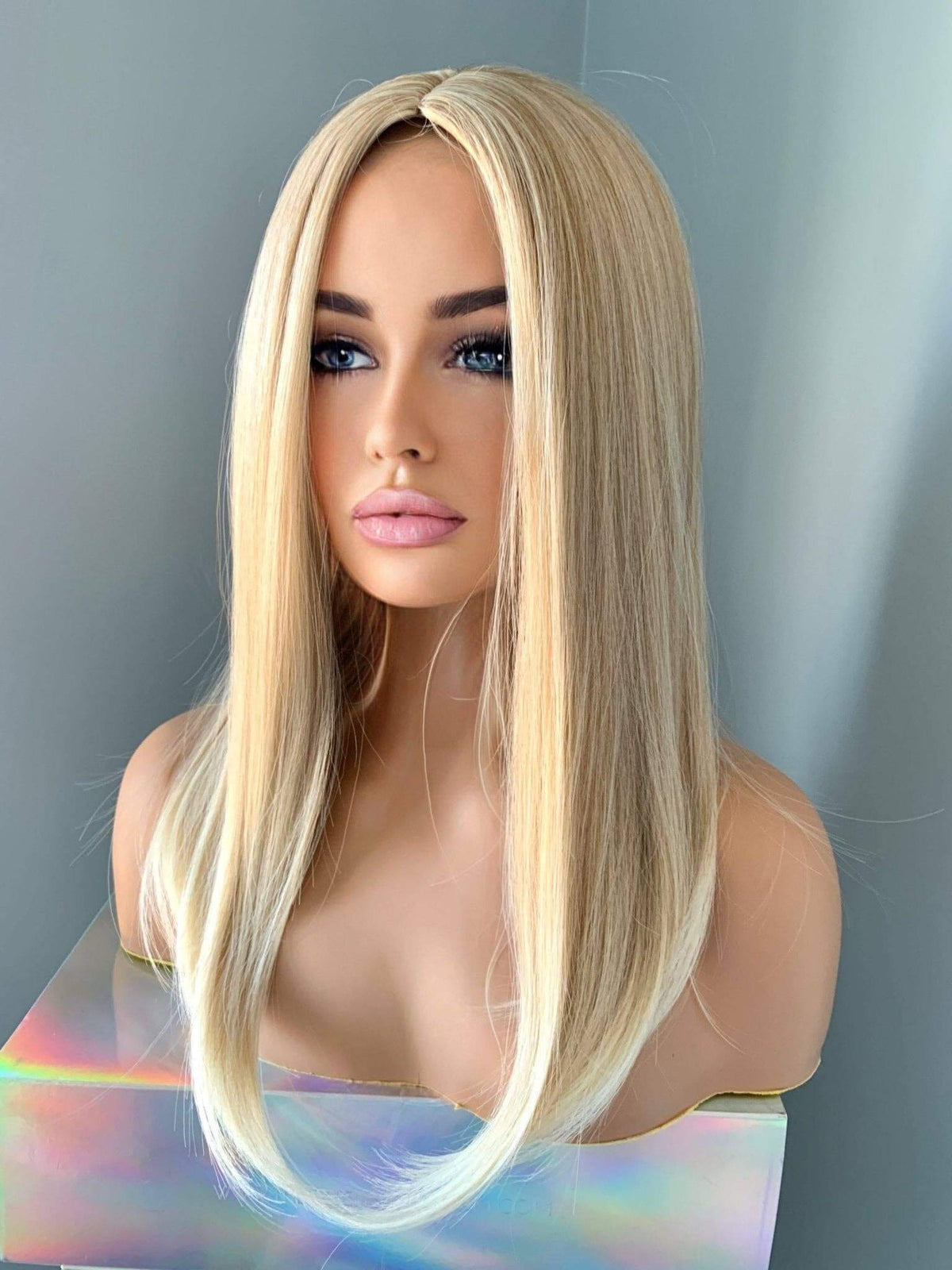 Hailey Silky Straight Blonde Wig displayed on a mannequin, showcasing sleek blonde locks and a flattering centre part.