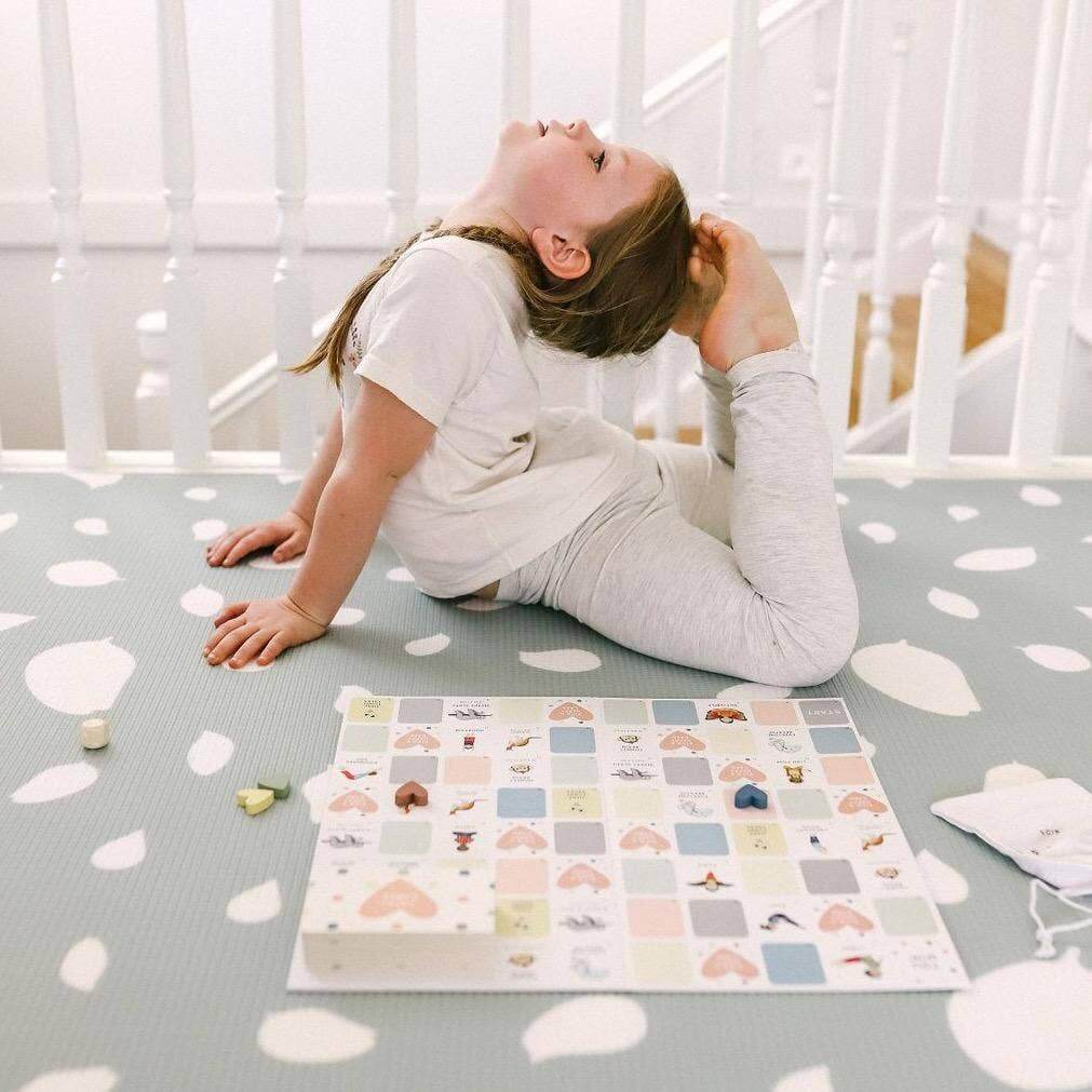 Child playing with a colorful puzzle on a patterned floor