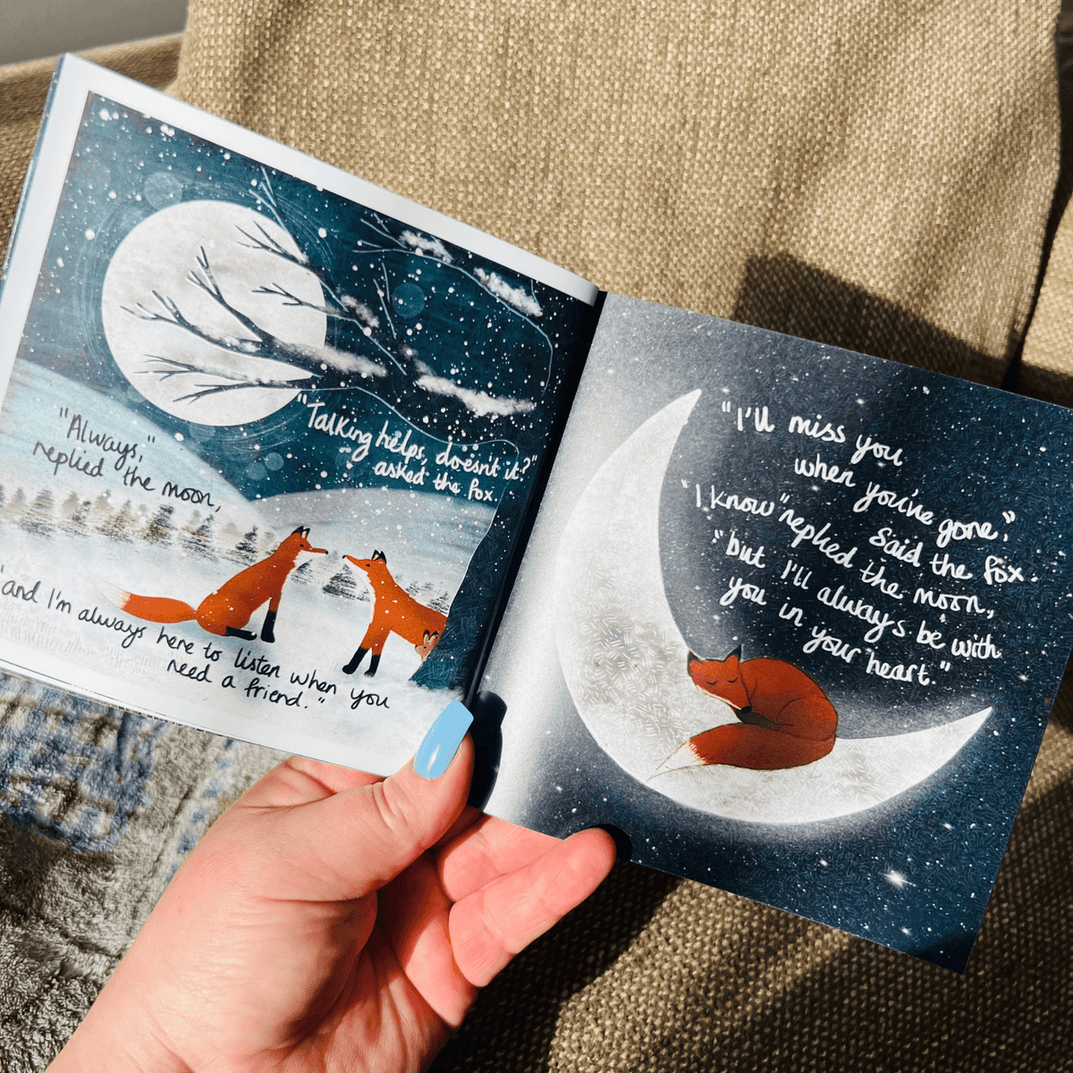 Hug In A Book mini book open to pages with illustrations of foxes talking under the moon.