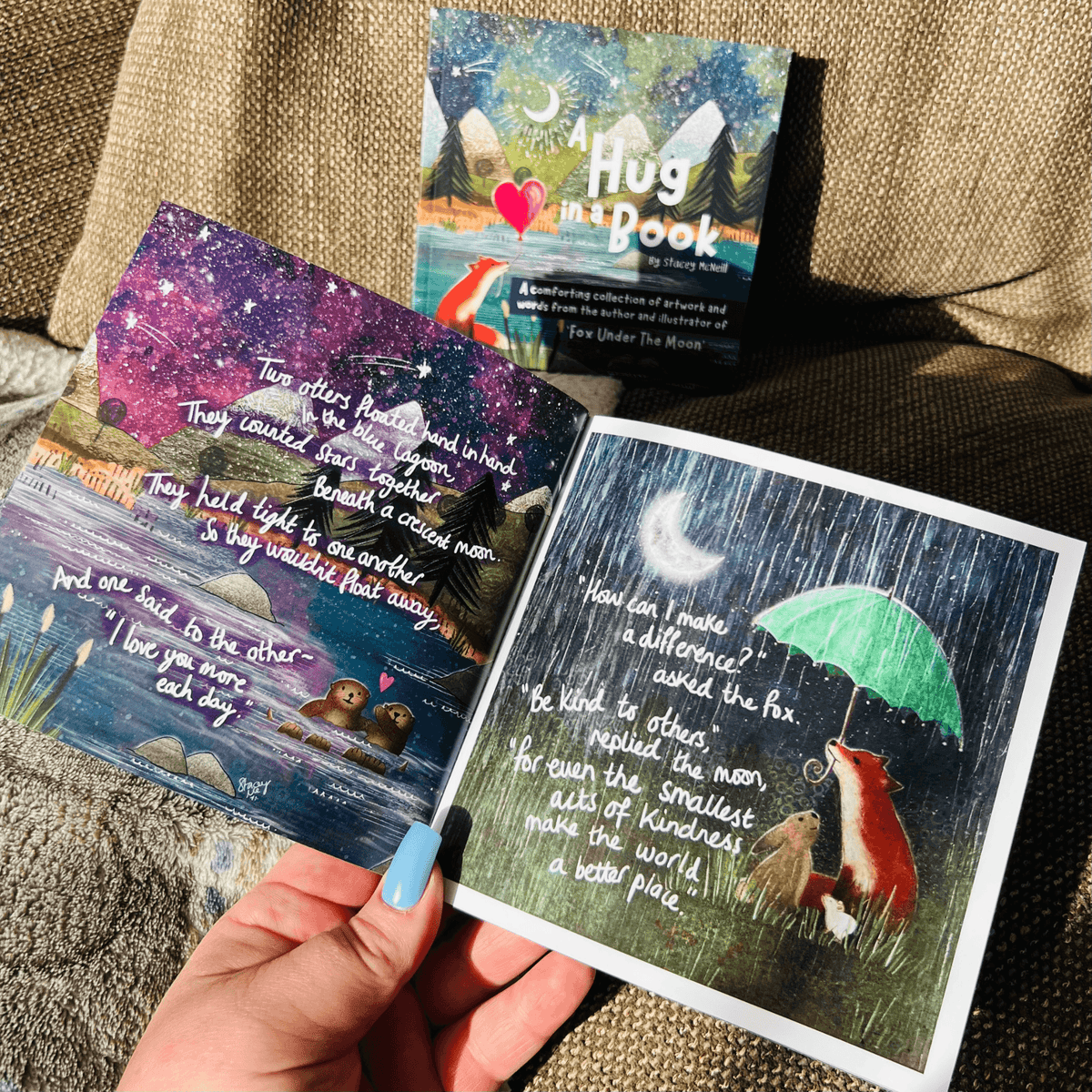 A close-up of pages from the Hug In A Book mini book showing uplifting illustrations and words.