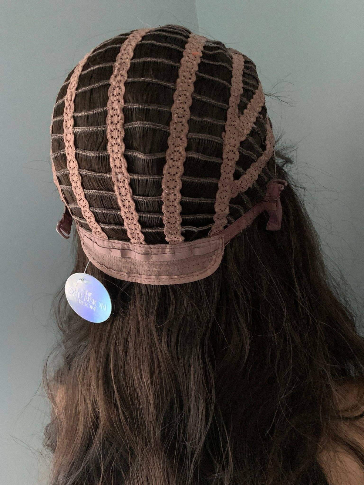 Dark Brown Wig cap design showing internal structure and adjustable straps for comfort.