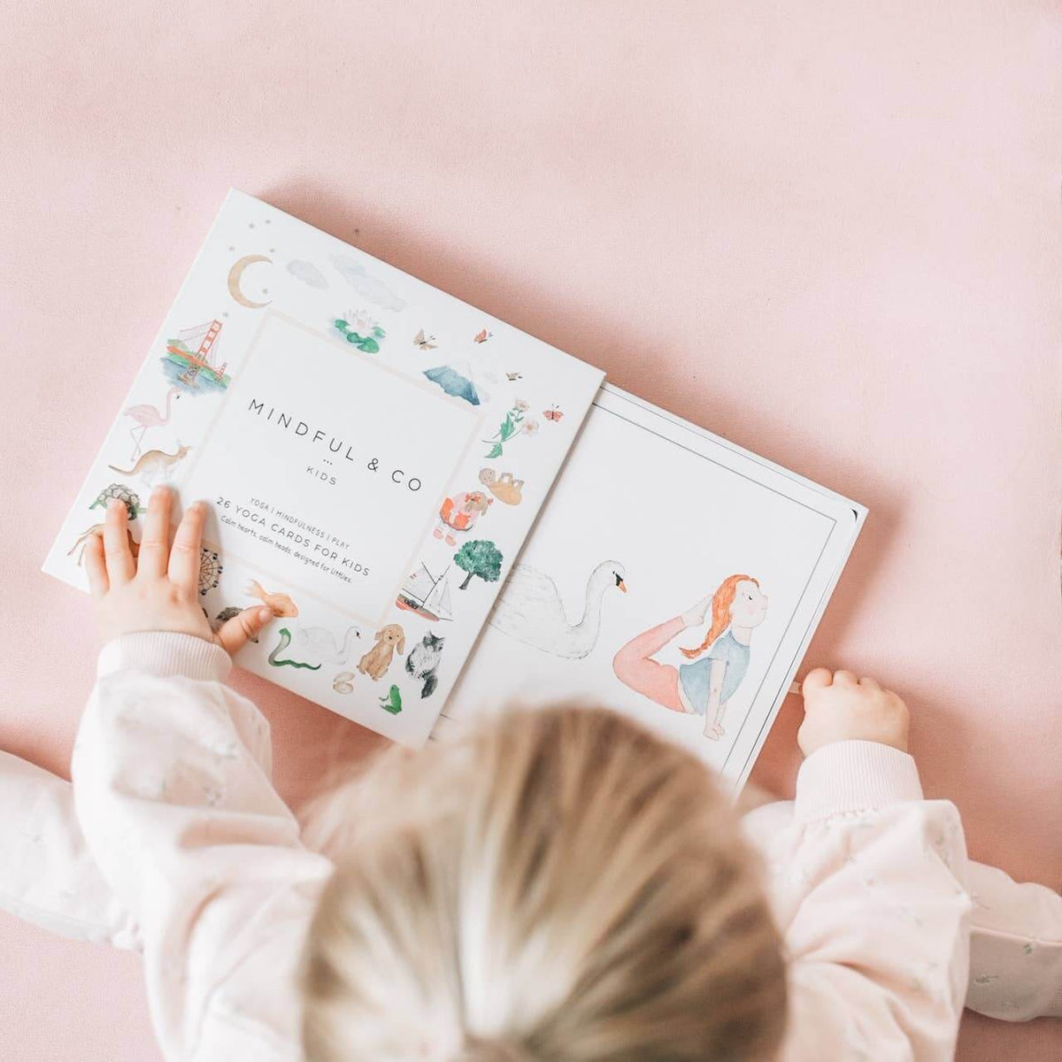 Child engaging with the Yoga Flash Cards, featuring creative illustrations that inspire mindfulness and movement.