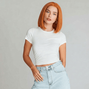 Model wearing Koi Orange Bob Lace Front Wig with blunt cut and natural middle, showcasing vibrant colour and sophistication.