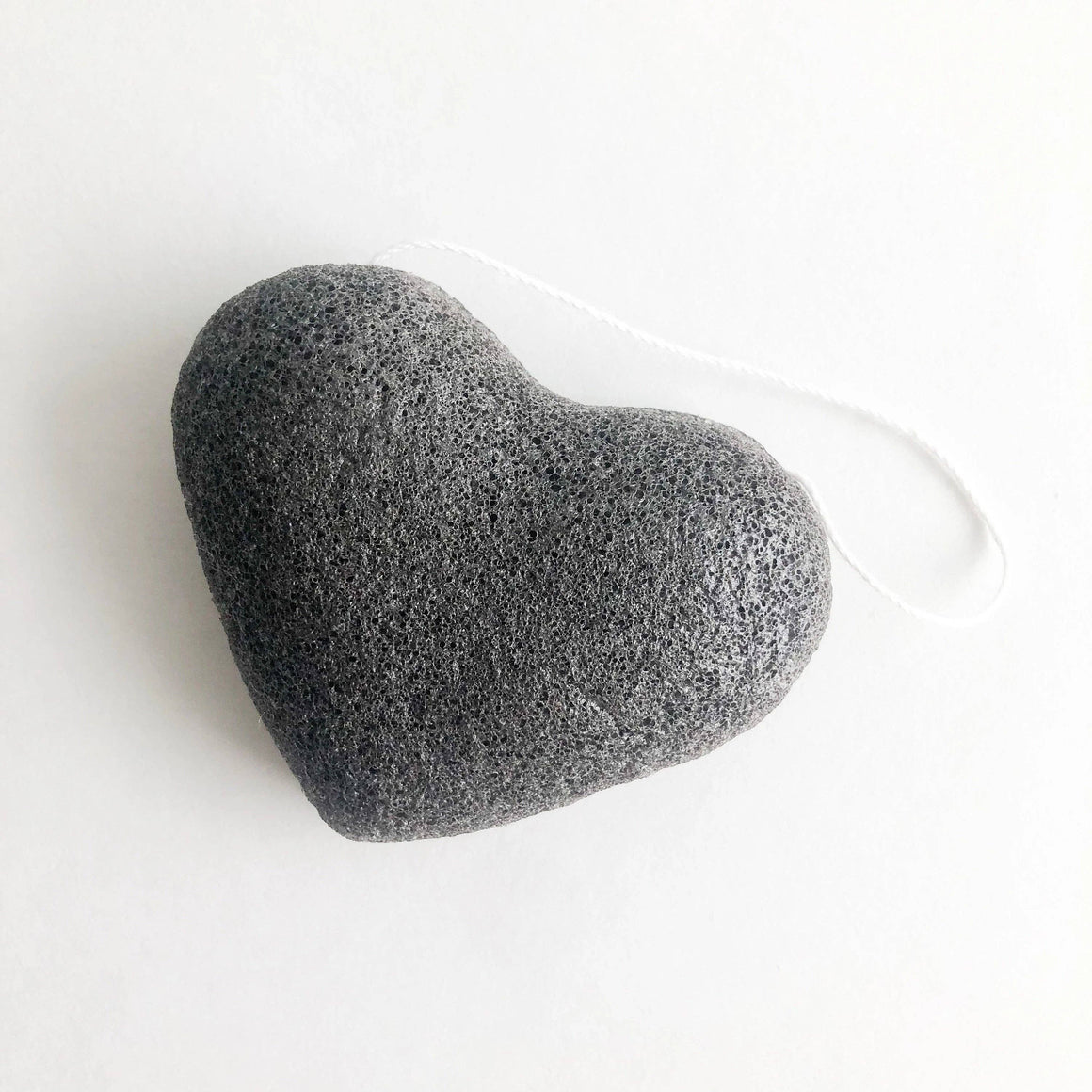 Heart-shaped gray sponge on a white background