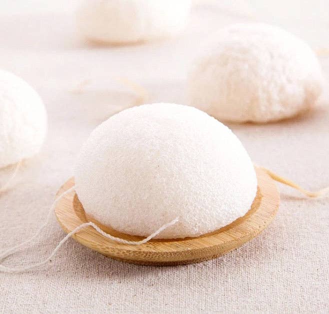 White laundry detergent pod on a wooden dish with a soft beige background