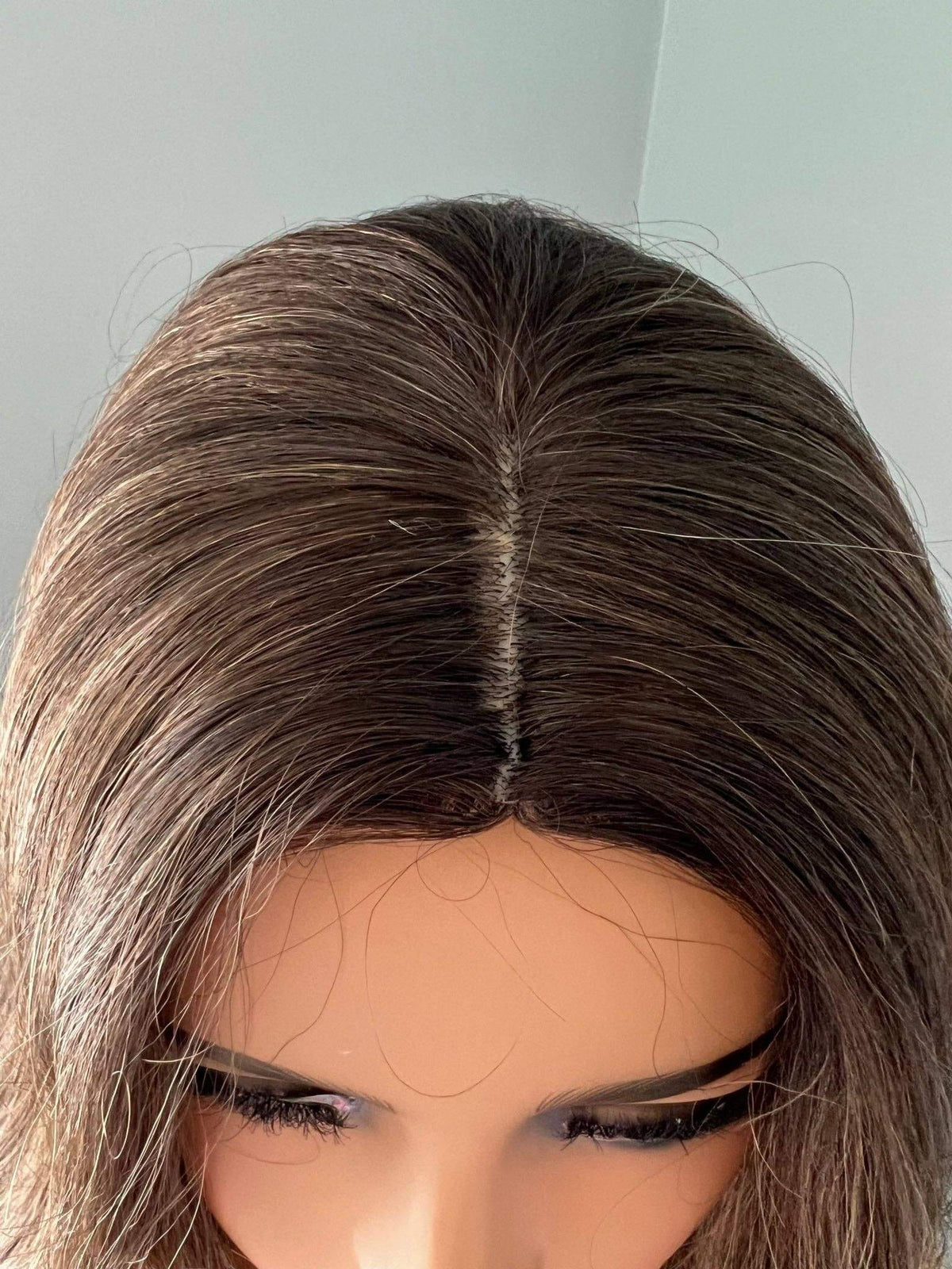 Top view of the Kylie Long Brown Curled Wig, showcasing its natural-looking hair part and soft brown curls.