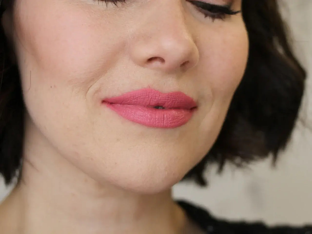 Close-up of a woman's lips wearing Maud Natural Lip & Cheek Rouge, showcasing a soft rose color.