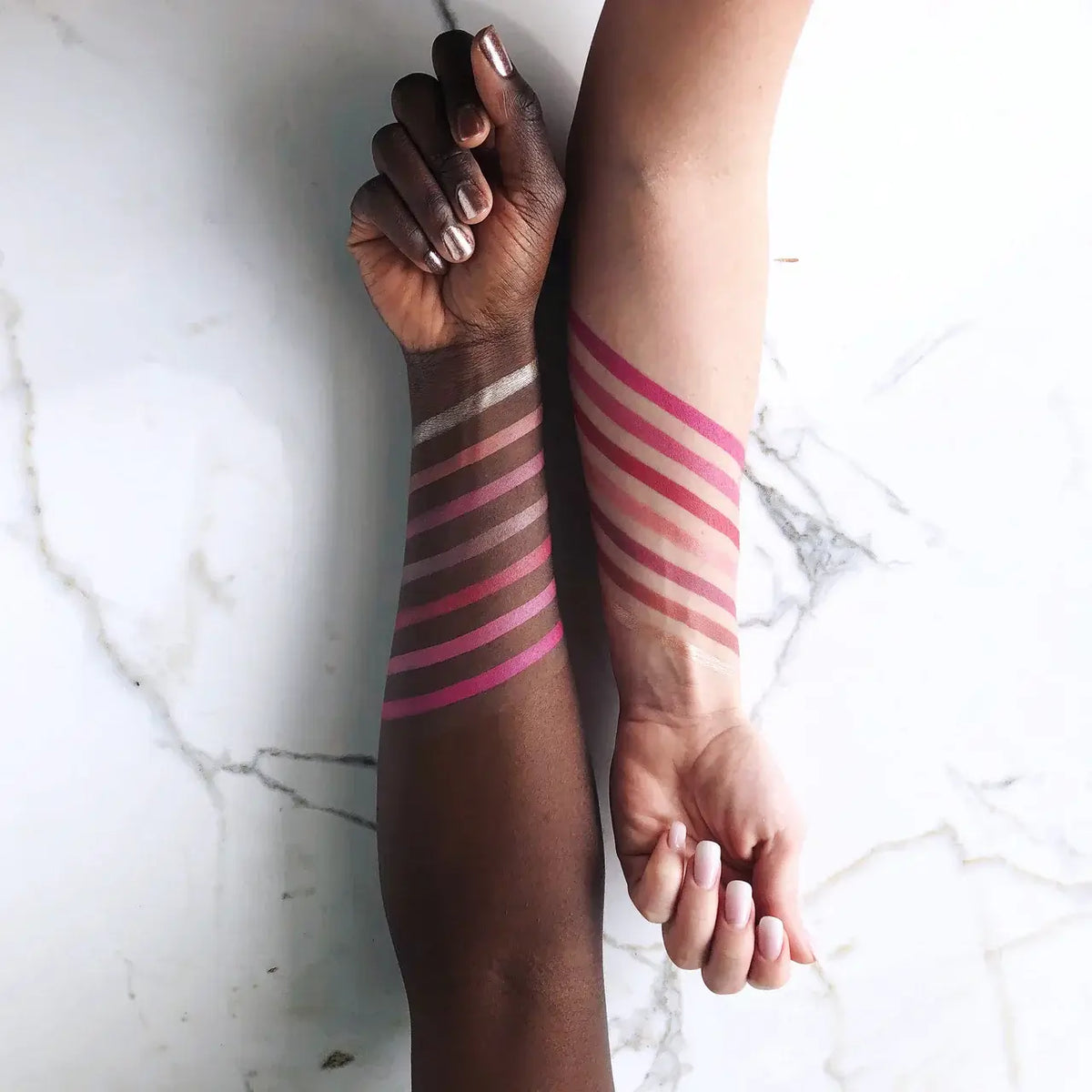 Swatches of Maud Natural Lip & Cheek Rouge on two arms showing various shades of cheek rouge.