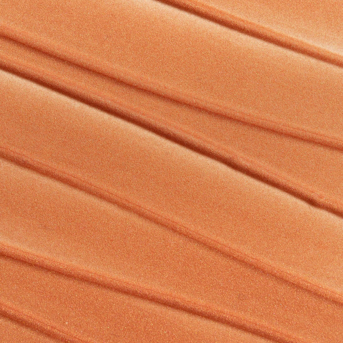 Close-up of pleated orange fabric