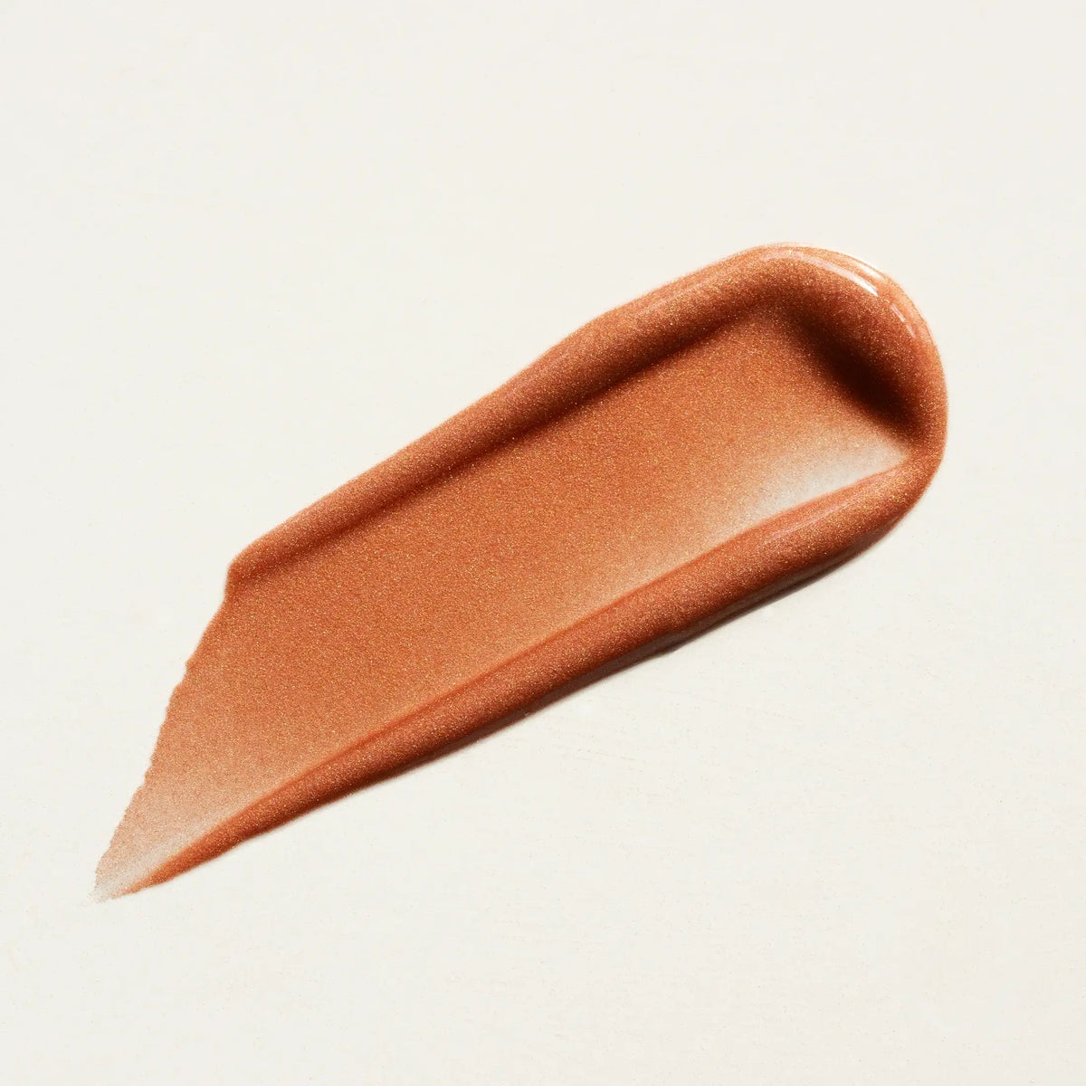 Brown cosmetic swatch on a light beige background