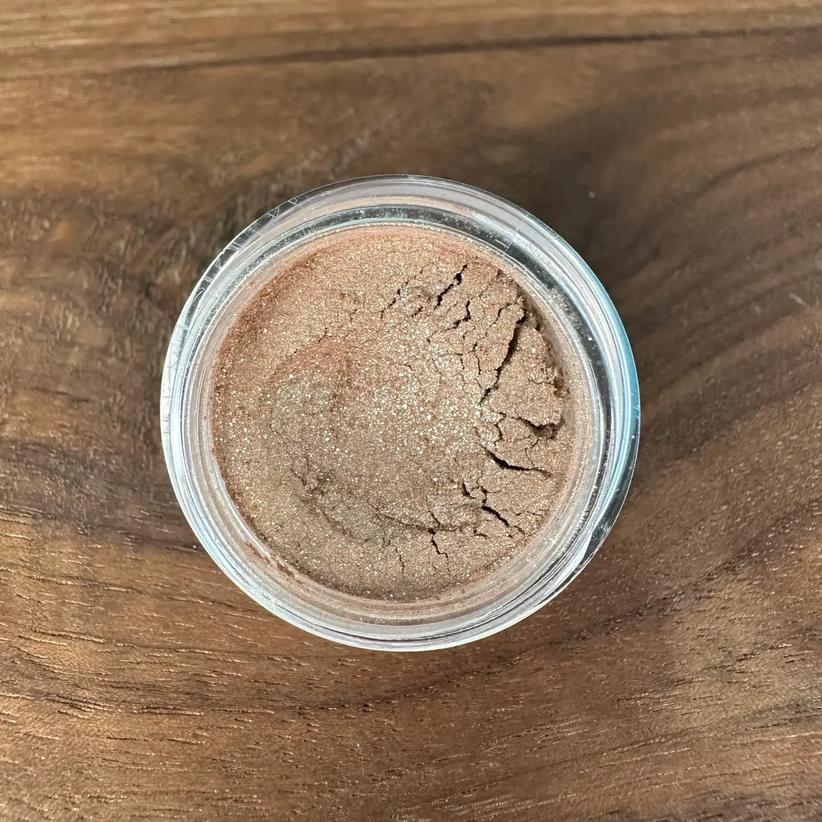Jar of brown powder on a wooden surface