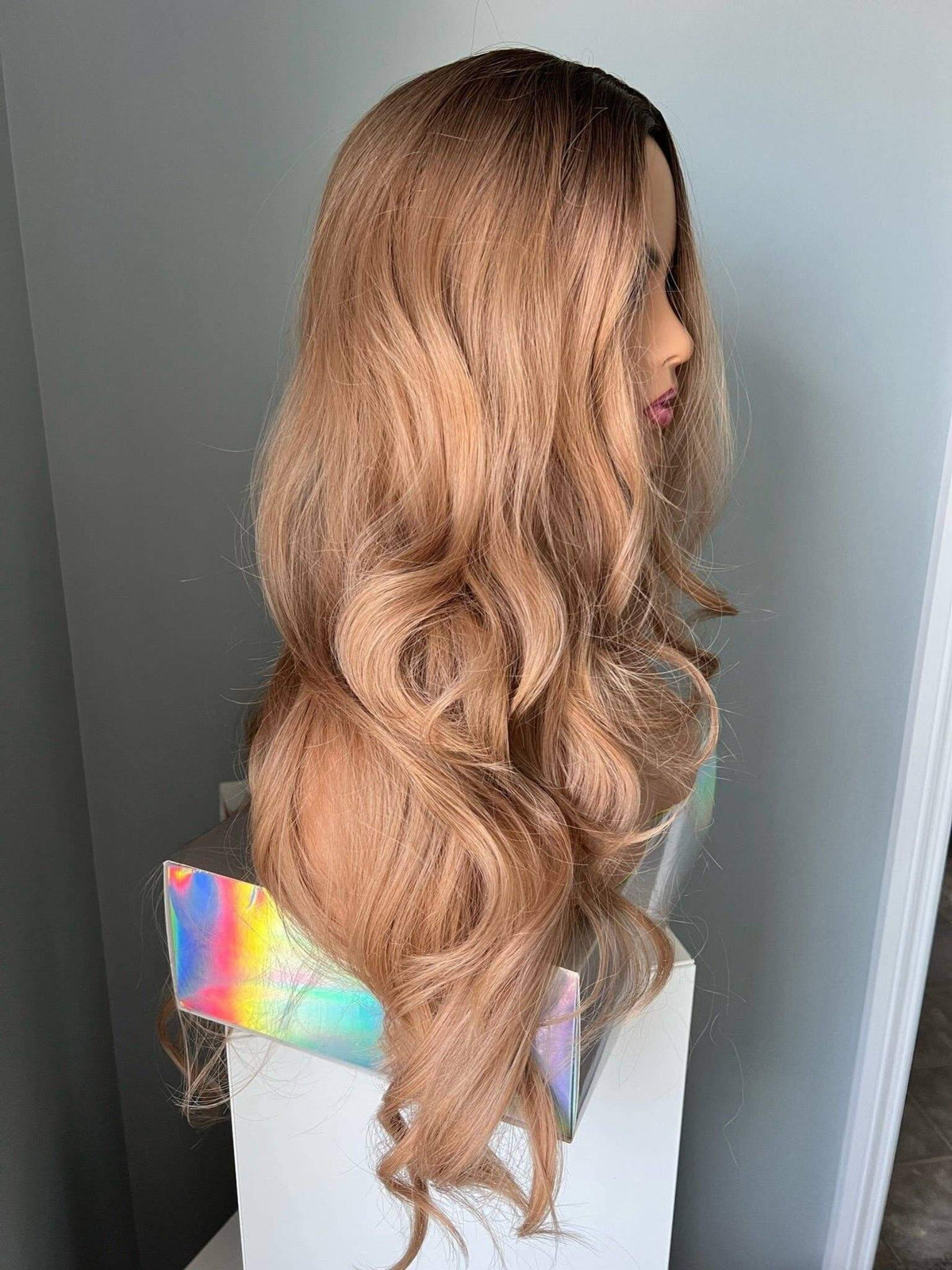 Margot Long Honey Blonde Curled Wig shown from the side, featuring luxurious soft curls and a blended honey blonde tone.