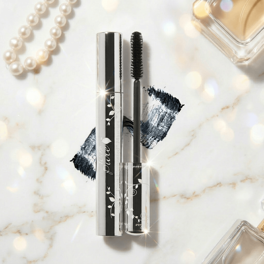 Mascara with brush and packaging on a marble surface