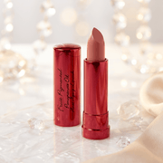 Lipstick with red casing and beige shade on a soft, blurred background