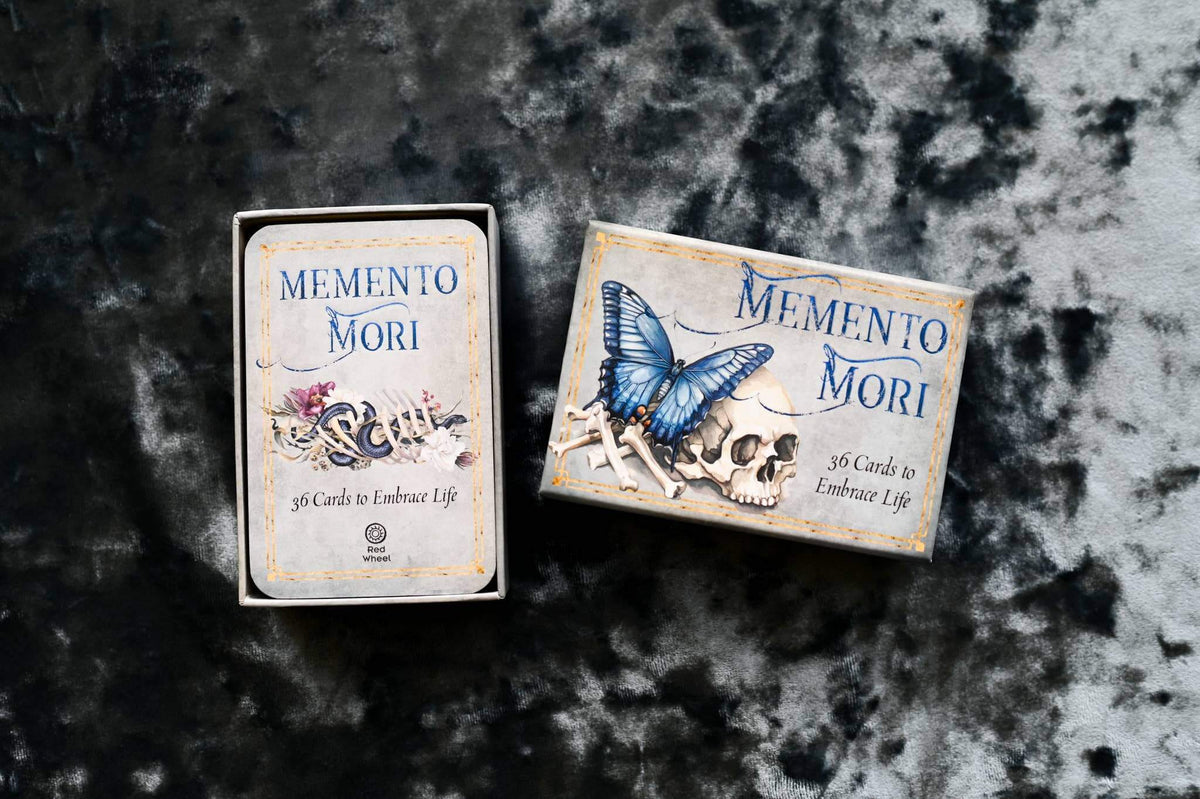 Memento Mori Cards packaging featuring artistic designs and affirmations for embracing life.