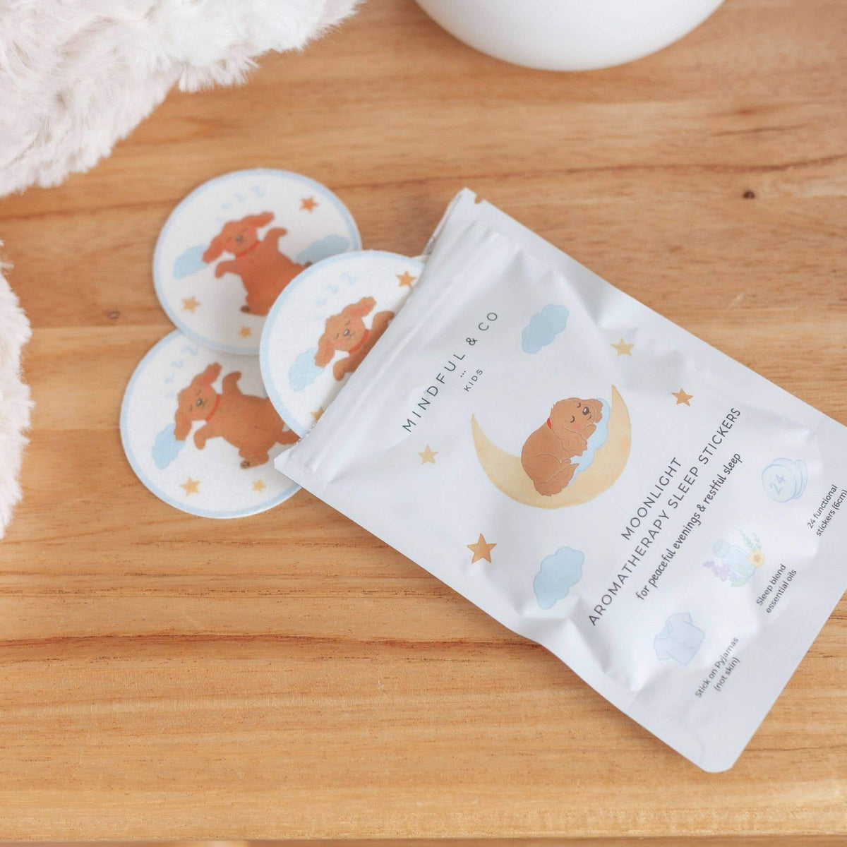 Moonlight Aromatherapy Sleep Stickers package and stickers for kids on a wooden surface.