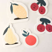 Set of fruit-themed stickers including lemons, pears, and cherries on a light background
