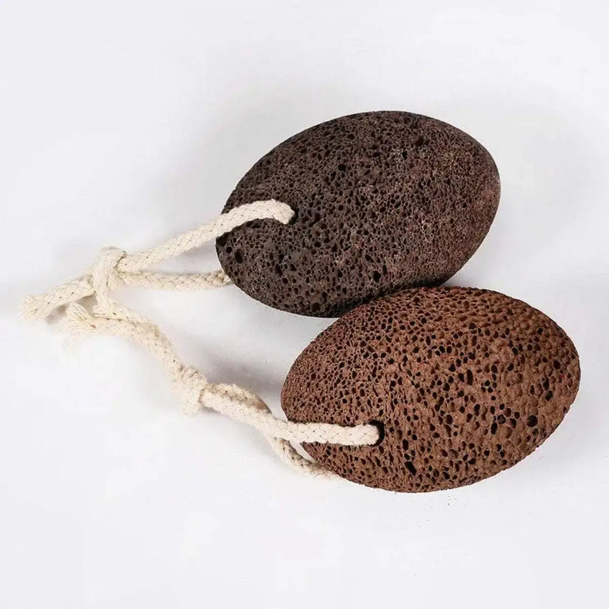 Two brown pumice stones on a white background