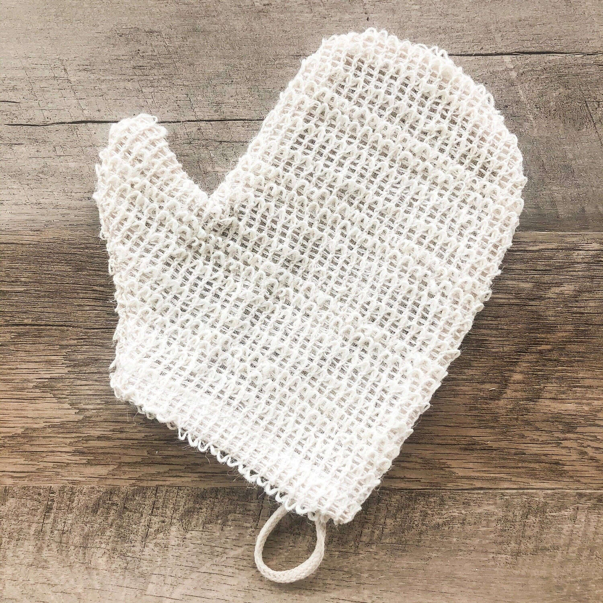 White mesh scrubber on a wooden surface