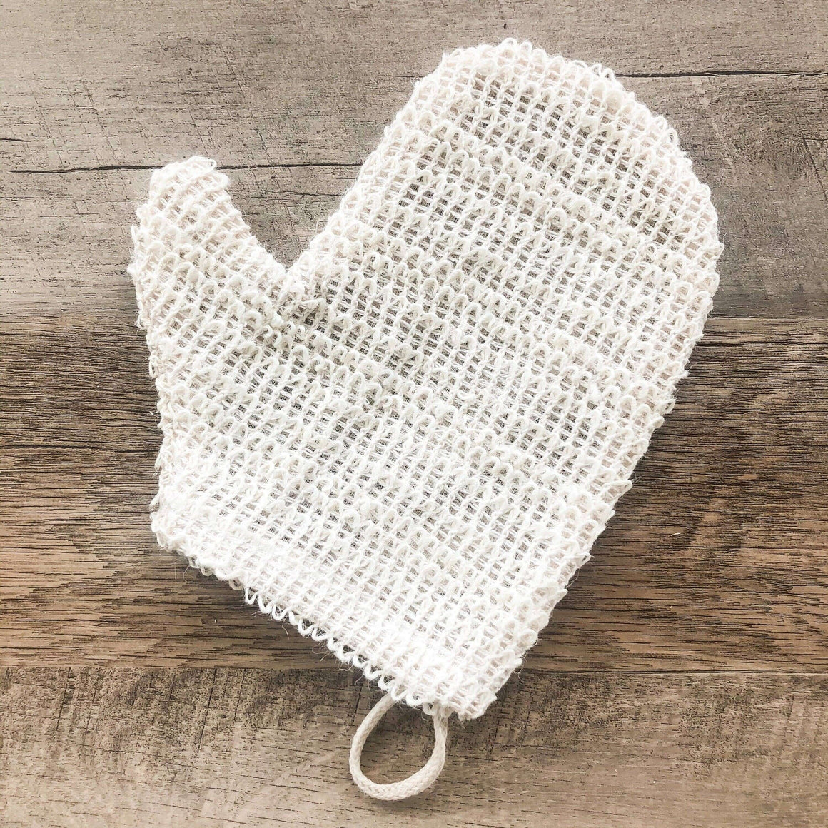 White mesh scrubber on a wooden surface