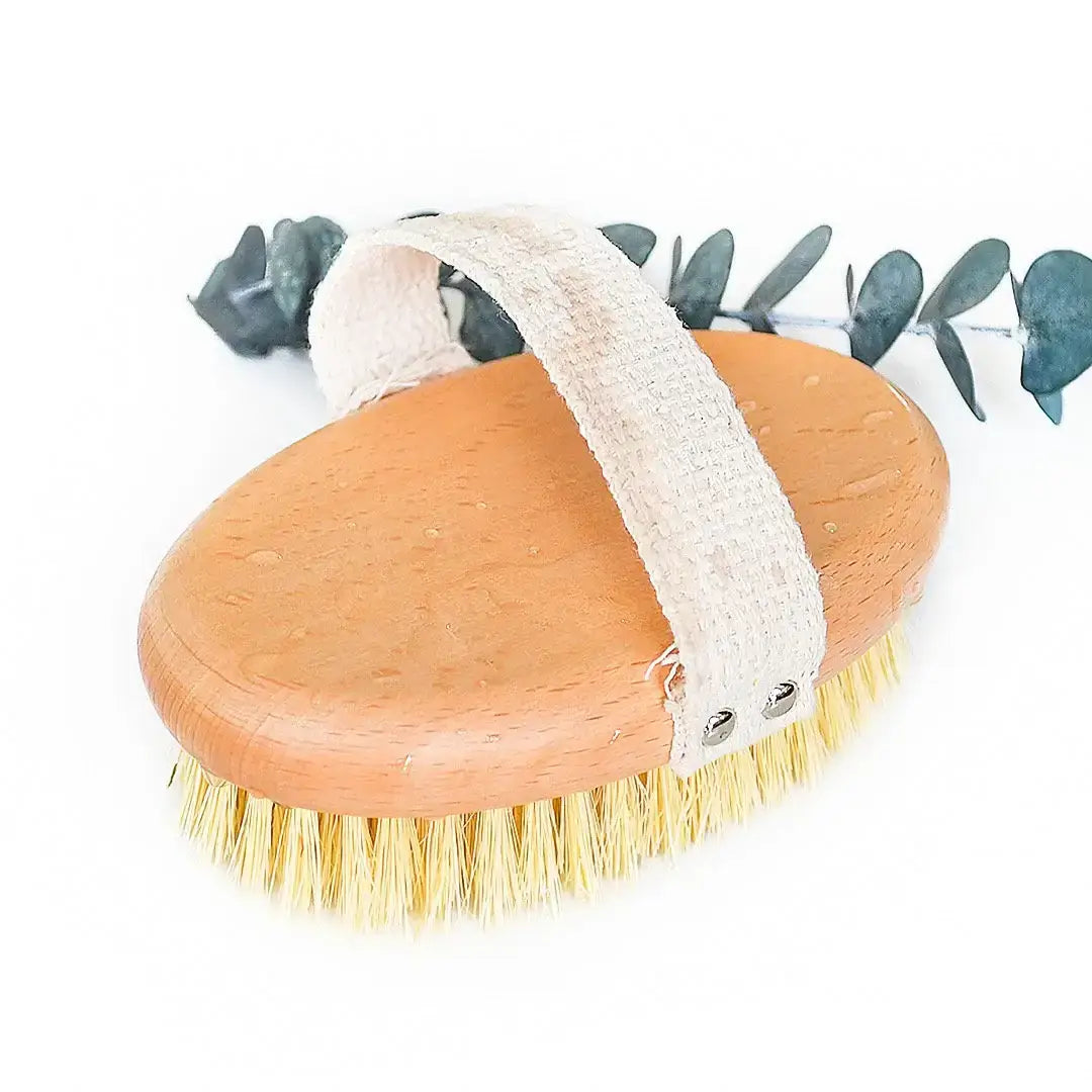 Sisal Bristle Body Brush - Smile Boutiques on a white background with eucalyptus leaves for natural touch.