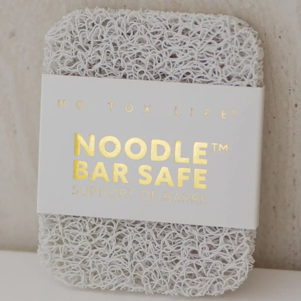 Noodle bar safe with 'No Tox Life' label on a neutral background